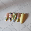 Colorful nail art designs on a marble floor